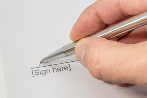 Close up of a contract being signed