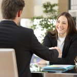 Two business people smiling after a negotiation.