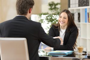 Two business people smiling after a negotiation.