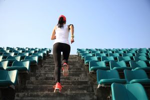 A women running up stadium stairs.