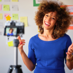 Woman in front of camera explains her business