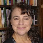 Karen Molander headshot in front of bookshelf