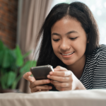 Woman smiles at phone