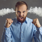 Angry professional man making fists, smoke coming out of his ears