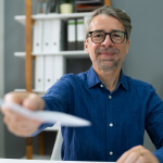 Smiling business partner hands over payment