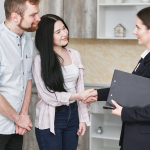 Professionally dressed woman shakes hands with prospective clients
