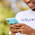 Volunteer looks at her mobile phone