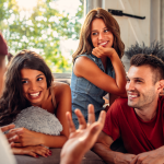 A man captivates a group of friends by telling a strong story