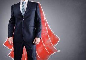 Superhero businessman with red cape drawing on background concept for leadership