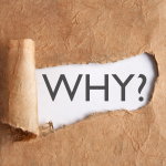 "why" appears behind torn brown paper
